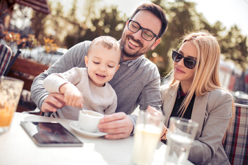 Happy young family in cafe
