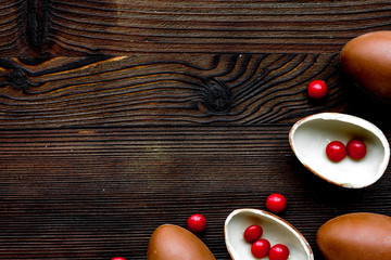 Easter chocolate eggs top view on wooden background mock up