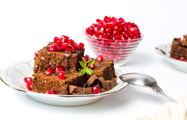 Chocolate cake with pomegranate on a plate