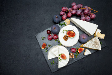 Camembert cheese and cut a slice on stone serving board