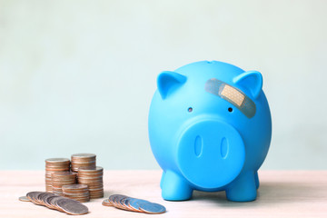 Blue piggy bank attached to the plaster on the head, Save money for Medical insurance and Health...