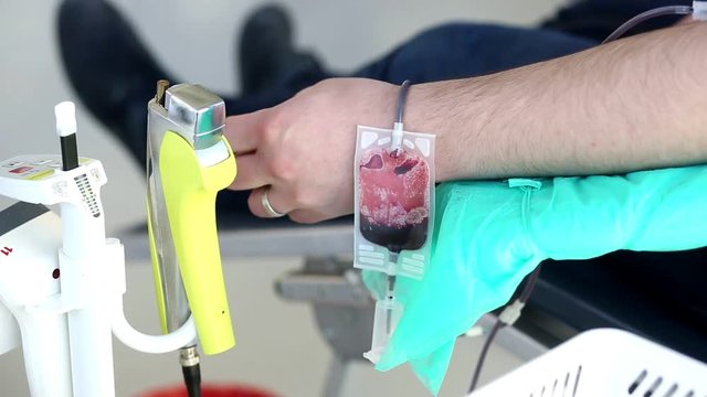 Blood donator donates blood in the hospital
