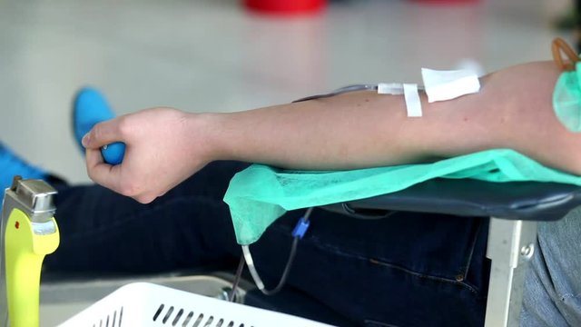 Blood donator donates blood in the hospital
