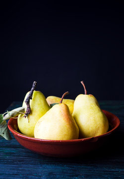 Pears on dark wooden background