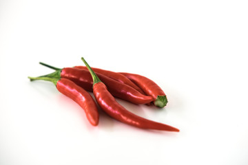 Group of red hot chili peppers isolated on the white background. Selective focus.