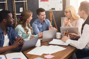 Young team discussing project in modern office