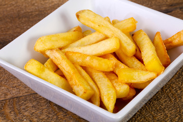 French potato over wooden background