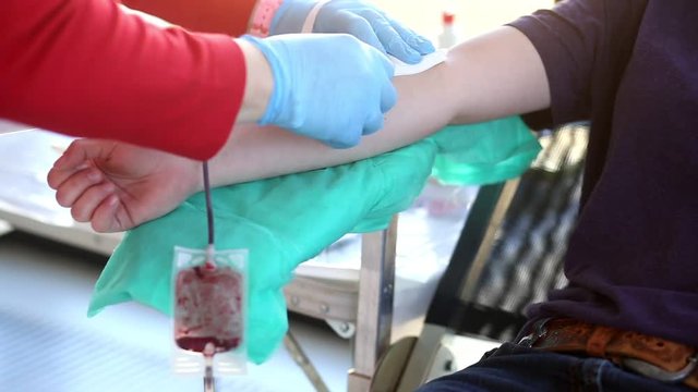 Blood donator donates blood in the hospital
