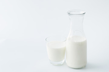 Milk bottle and milk glass isolated on white background.