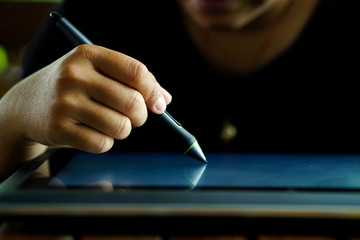 Close up Hands with pen writing on the modern graphic tablet