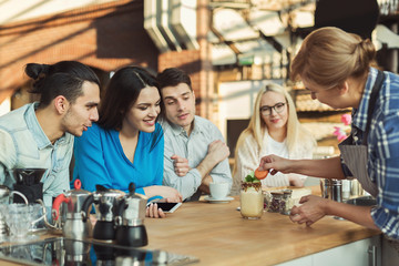 Experienced smiling barista giving master class