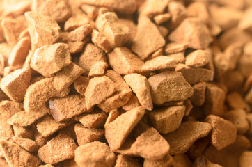Granules of instant coffee in macro as background.