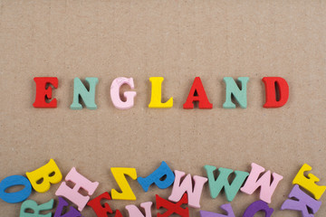 ENGLAND word on paper background composed from colorful abc alphabet block wooden letters, copy space for ad text. Learning english concept.