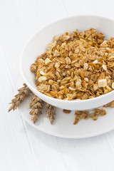 homemade baked muesli in white bowl, vertical