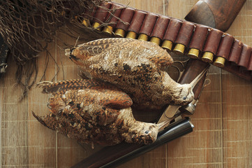 Hunting trophies and equipment lie он wooden board. Hunting of woodcock birds. Horizontal.