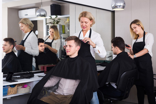 hairdresser cutting hair of male