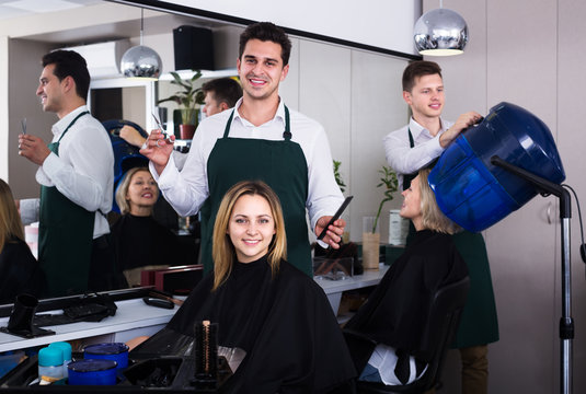 Hairdresser cuts hair at salon