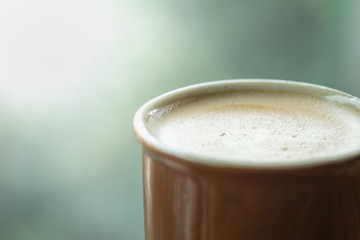 Close up of cup (mug) of hot coffee latte.