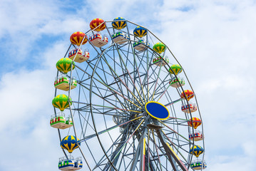 Colorful Ferris wheel against the blue sky.