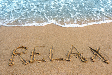 Inscription relax on the sand.