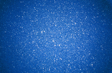 Blue vignetted texture background with white specks