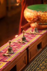 Hand bells and a dorje on special ritual little tables, against the background of a bass drum, in the Buddhist monastery, waiting for arrival of monks.