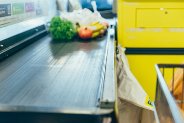 products on the cash desk. grocery shopping. out of focus
