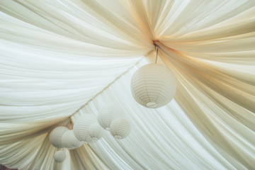 Canopy from fabric of dairy color with the Chinese  flashlights