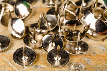 Thumb tacks on a wooden board