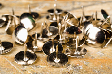 Thumb tacks on a wooden board