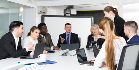 Multinational group of confident business colleagues planning work