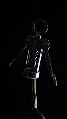 Wine bottle, corkscrew and light