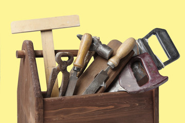 Old Carpenter Wooden toolbox with tools isolated on white