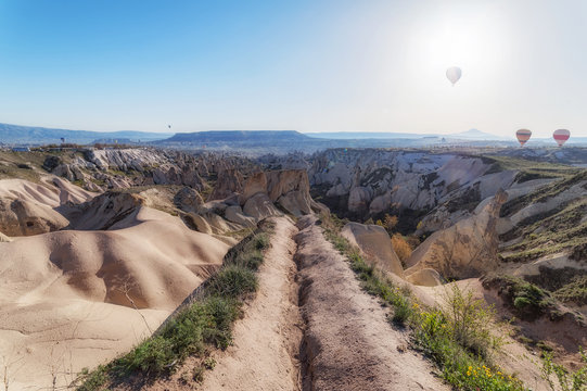 panoramic view of colorful hot air balloons flying over the Love valley on sunrise.Goreme, Cappadocia, Turkey