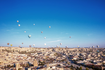 Goreme, Cappadocia, Turkey - 31 March, 2018:  view of colorful hot air balloons flying over the  valley on sunrise.