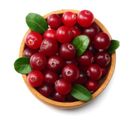 Cranberry in wooden bowl with green leaves isolated on white background. top view