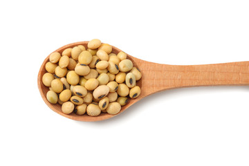 Soybeans in wooden spoon isolated on white background. top view