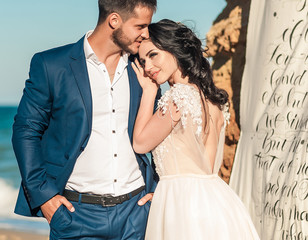 wedding couple, groom and bride in wedding dress near the sea at the seaside