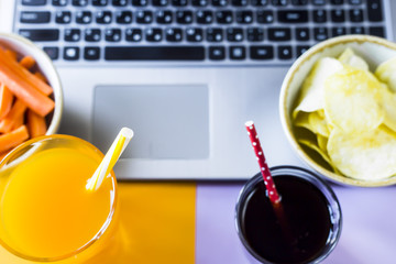 Choose a snack - healthy eating carrots with juice or harmful food chips with cola. Food in the break between working on a laptop