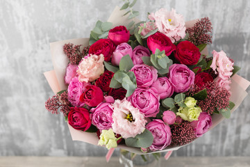 Close-up Beautiful Bouquet. Spring flowers on gray background. flower shop. Wooden table