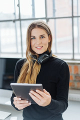 Young smiling woman using digital tablet