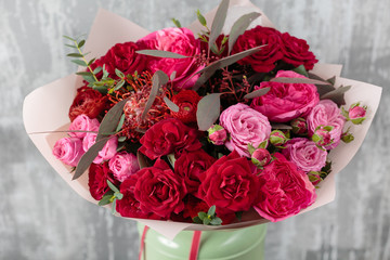 Close-up Beautiful Bouquet. Spring flowers on gray background. flower shop. Wooden table