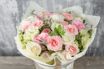 Close-up Beautiful Bouquet. Spring flowers on gray background. flower shop. Wooden table