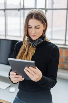 Young woman listening to music browsing for a tune