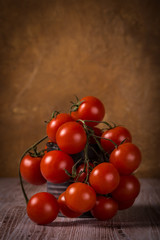 Juicy fresh red tomatoes on wooden board in vintage can