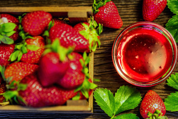Fresh strawberries in wooden box and liqueur close
