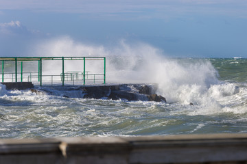 Sea Waves Breaking against Seashore Promenade in Windy Day: Stormy Weather