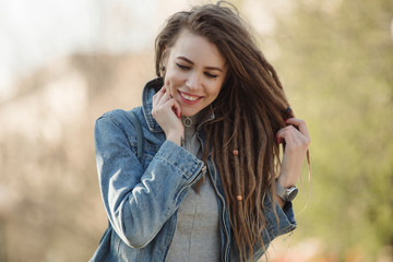 Smiling portrait of fashionable woman with dreadlocks