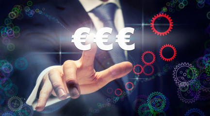 A businessman pressing a Euros business concept on a graphical display of cogs