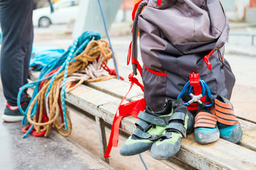 climbing equipment ropes carbines backpacks suspension for sitting climber and special shoes for rock climbing and people in training